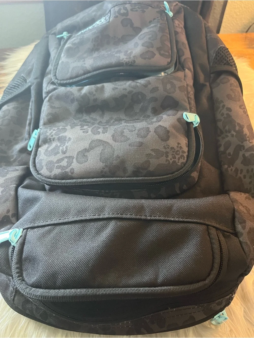 Dakine Black Leopard-Print Backpack with Teal Zipper Accents